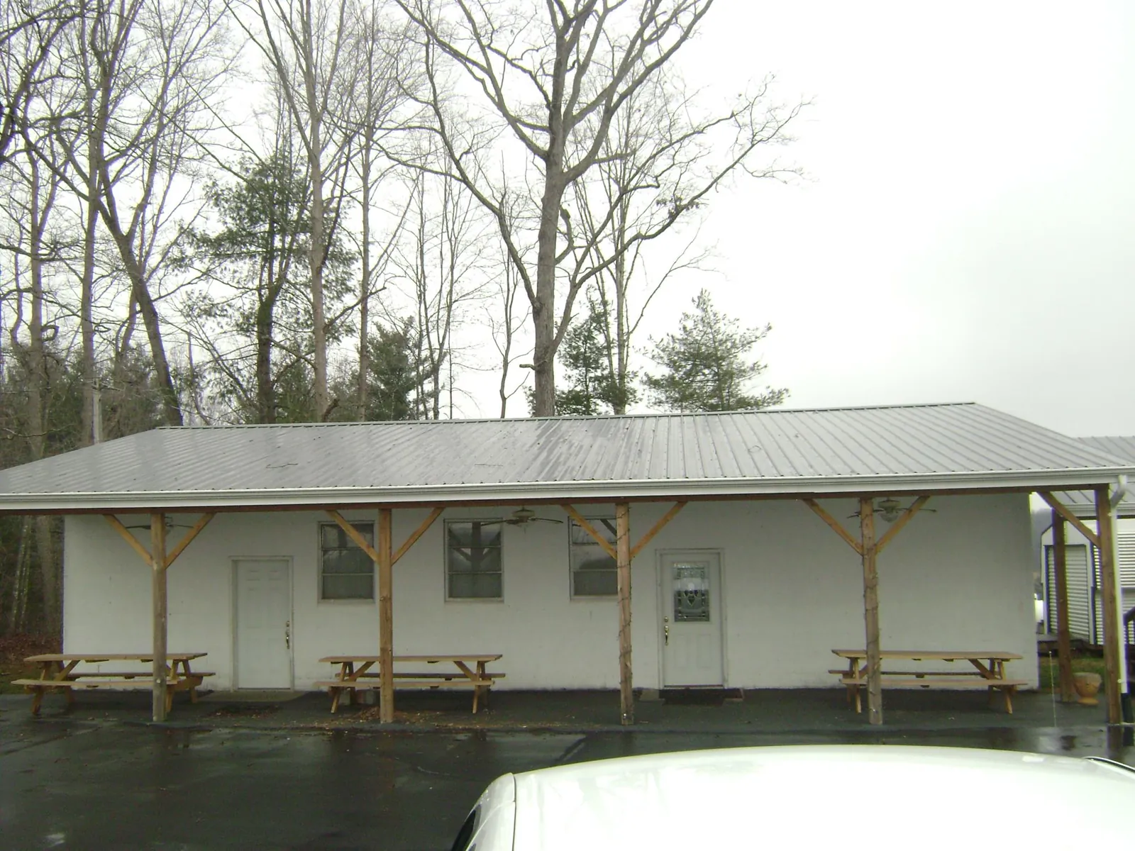 Gray metal roof over a block building with a timber post porch in Port Haywood